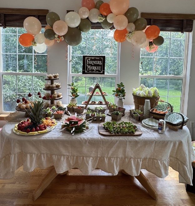 Home 7 A long dessert table of tiered stands and fresh fruit beneath a Blessed sign