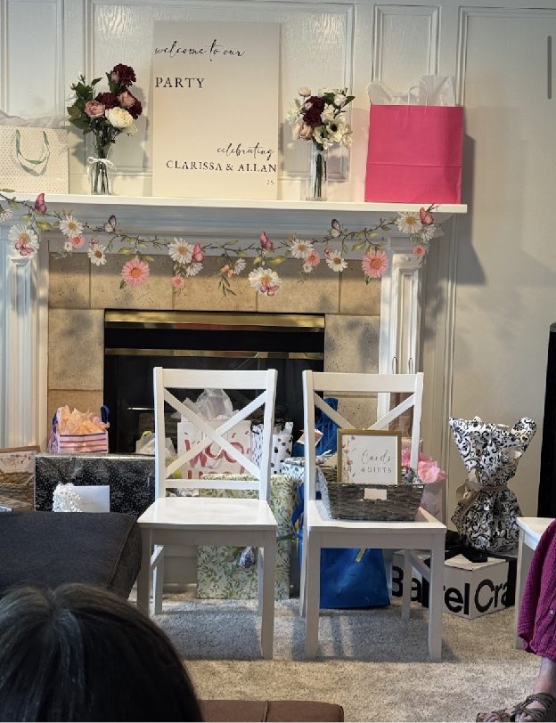Home 12 A white mantel lined with framed photographs, gifts and candy jars for a graduation celebration