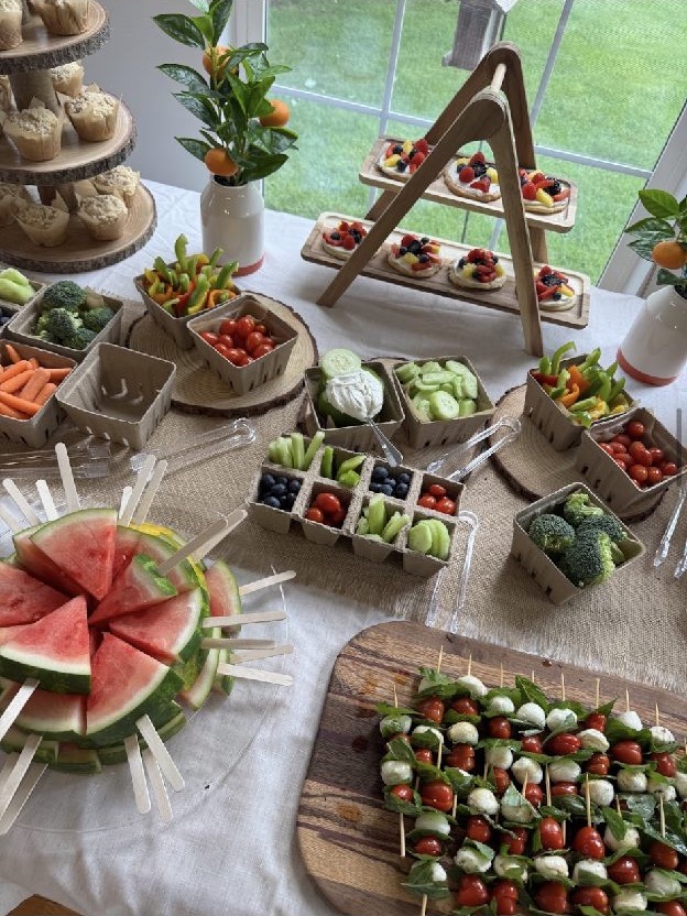 Services 4 A long grazing table of fresh fruit and vegetables with a carved watermelon centrepiece
